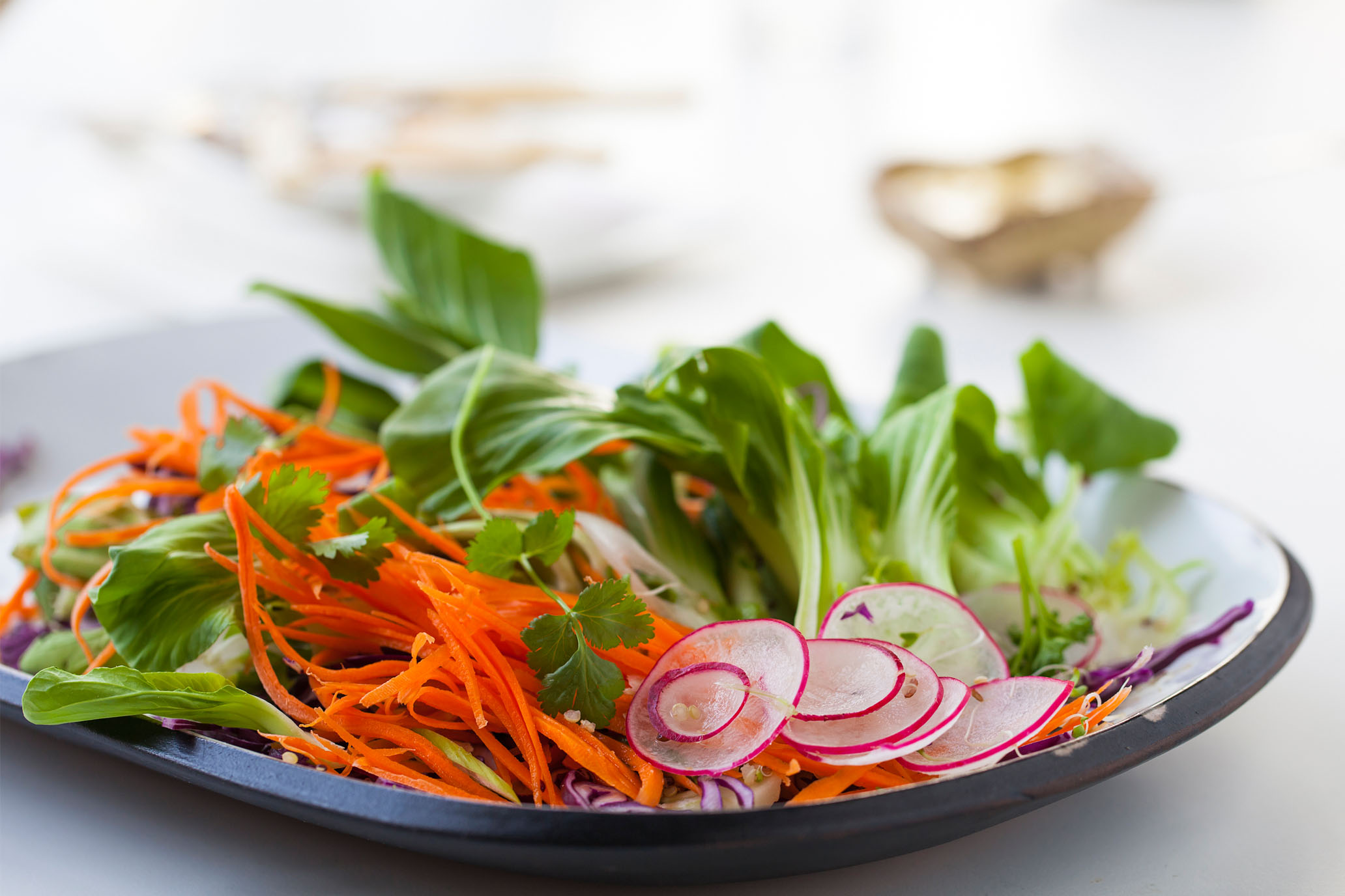 Image of a fresh green salad including onions, carrots, and cabbage.